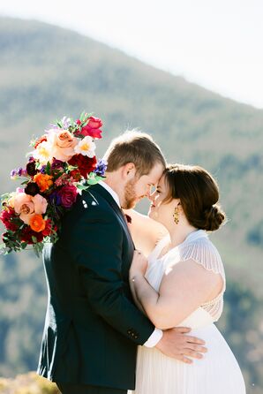 Bride With Updo and Colorful Bouquet Hugging Groom