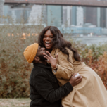 Man and woman hugging after proposal during the winter