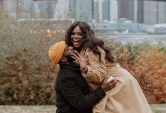 Man and woman hugging after proposal during the winter