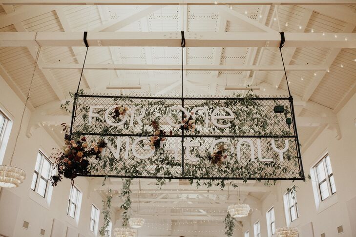 Hanging Sign Decorated With Greenery at BLDG 177 in San Diego, California