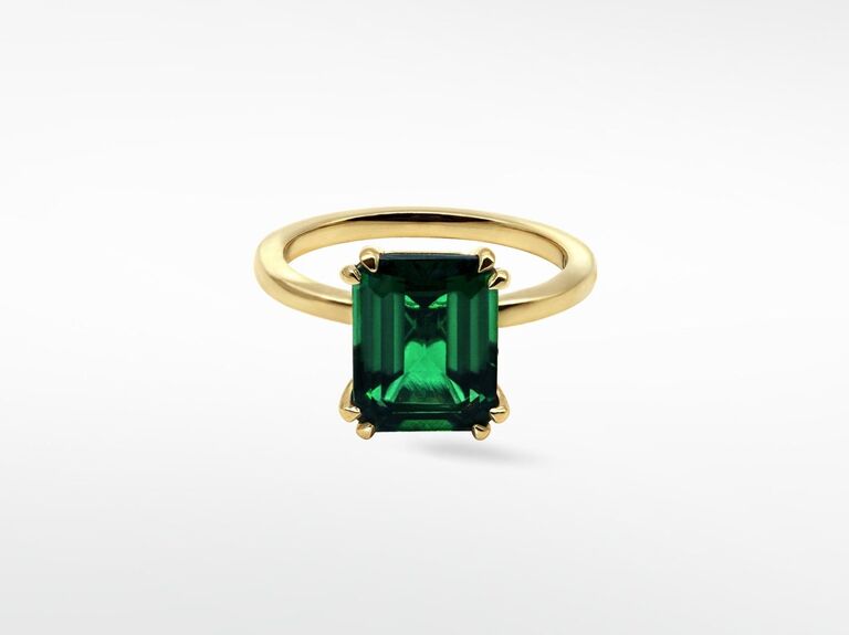 Emerald-cut emerald ring with a gold band. 