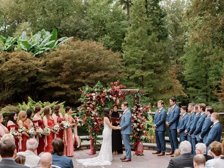 Red and Orange Florals Decorated This Fall Wedding Ceremony Arch