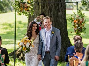Gia Rodriguez and Kurt Knisely celebrated their love with a ceremony beneath an arch with minimal flower arrangements at Schiller Park. "We both love 