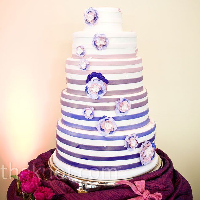 Ombre-style fondant  bands and sugar flowers decorated the round cake.