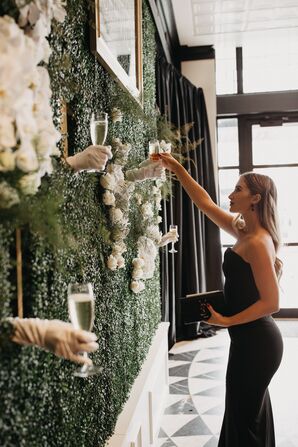 Gloved Servers Hand Glasses of Champagne to Guests Through Holes in Shrubbery