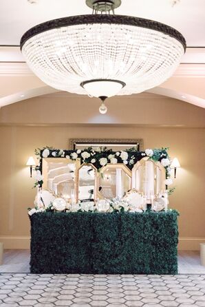 Gilded Mirrored Escort Card Display on Greenery Wall