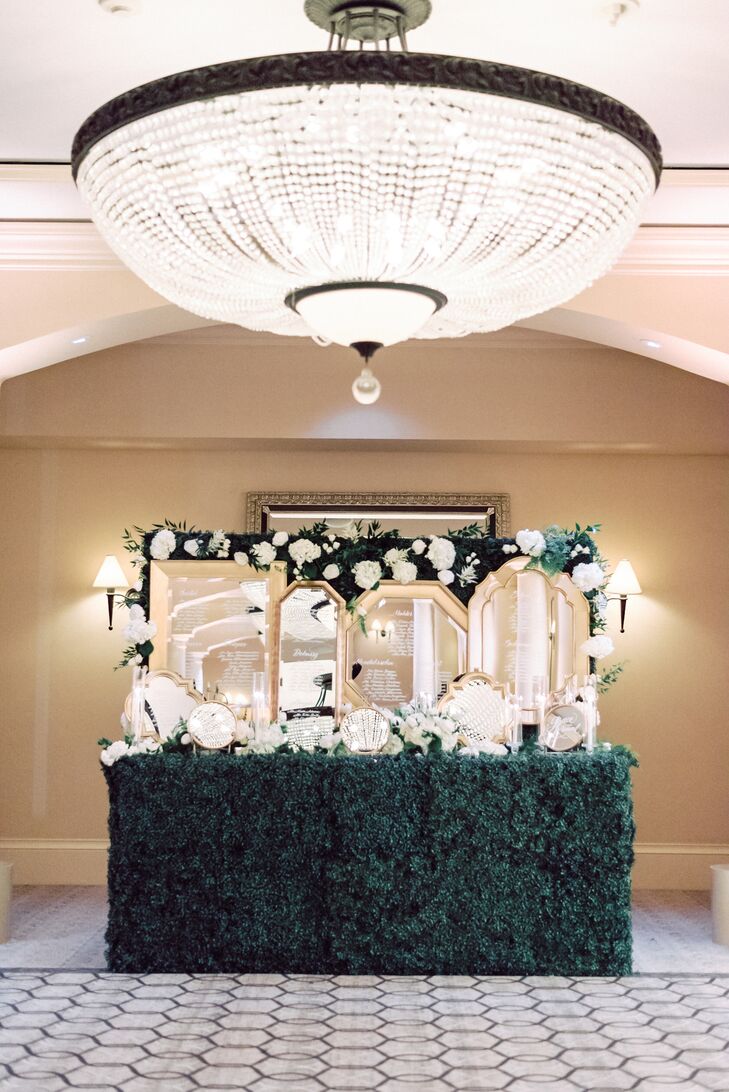 Gilded Mirrored Escort Card Display on Greenery Wall