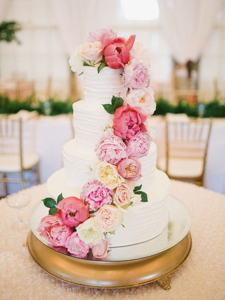 white buttercream wedding cake with cascading garden rose and peony decoration