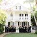 Wedding Party in All-Black Attire in Front of Estate