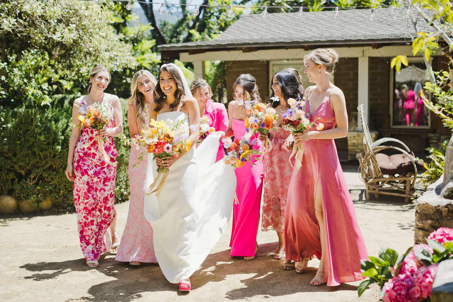 Bride in Sleek Gown With Bridesmaids in Hot, Bright Pink Dresses,  Wildflower Bouquets