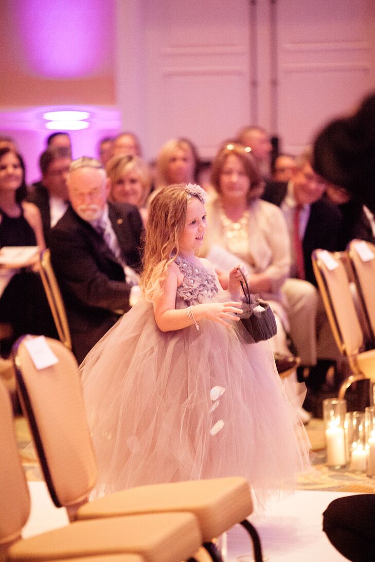 The flower girl carried a basket with wedding dress pieces sewn onto the top from three generations, and she threw ivory and pink rose petals.