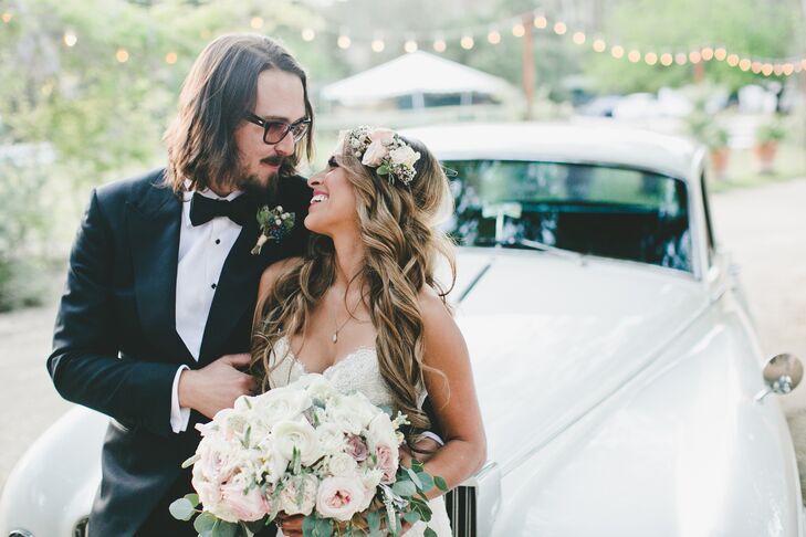 Marisa had ivory and pink roses pinned into her long wavy hairstyle, elegantly draping over the top of her ivory Marisa Bridals dress. Marisa held a romantic arrangement of ranunculus, roses, peonies and veronica.