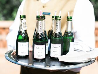 Waiter serving champagne bottles at a wedding