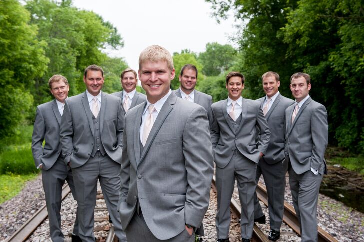Andy's groomsmen wore dark gray tuxedos with blush ties. Andy even won the tuxedos at a bridal show that Amber admits she forced him to attend.
