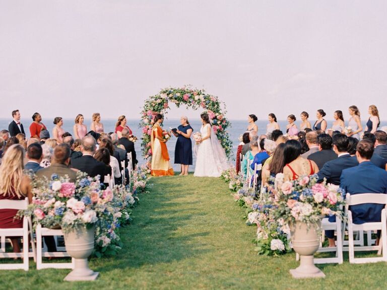 couple during wedding ceremony with hydrangea ceremony arch
