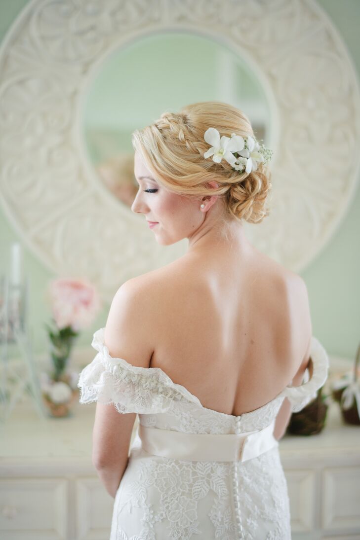 Erica had her hair styled in a romantic updo with a simple braid. White orchids and baby’s breath were placed above the bun in lieu of a traditional veil. “For jewelry I wore pearl earrings Cole gave me previously and nothing else. I felt too much would take away from the dress,” she says.