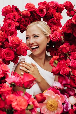 Bride Surrounded by Red and Pink Spray Roses