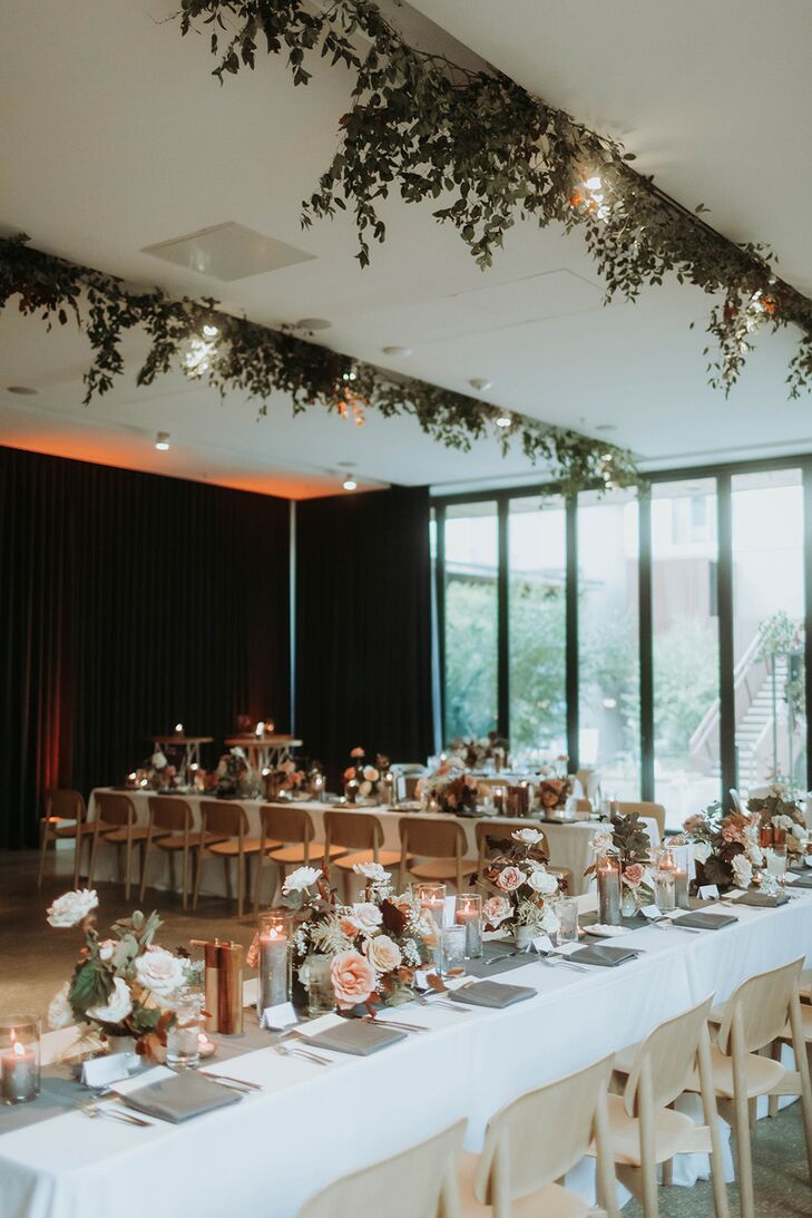 Long Reception Tables With Low Centerpieces, Gray Details and Hanging Greenery in Hotel
