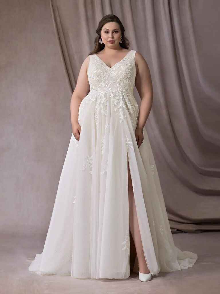 Model wears a petite wedding dress by Azazie. 