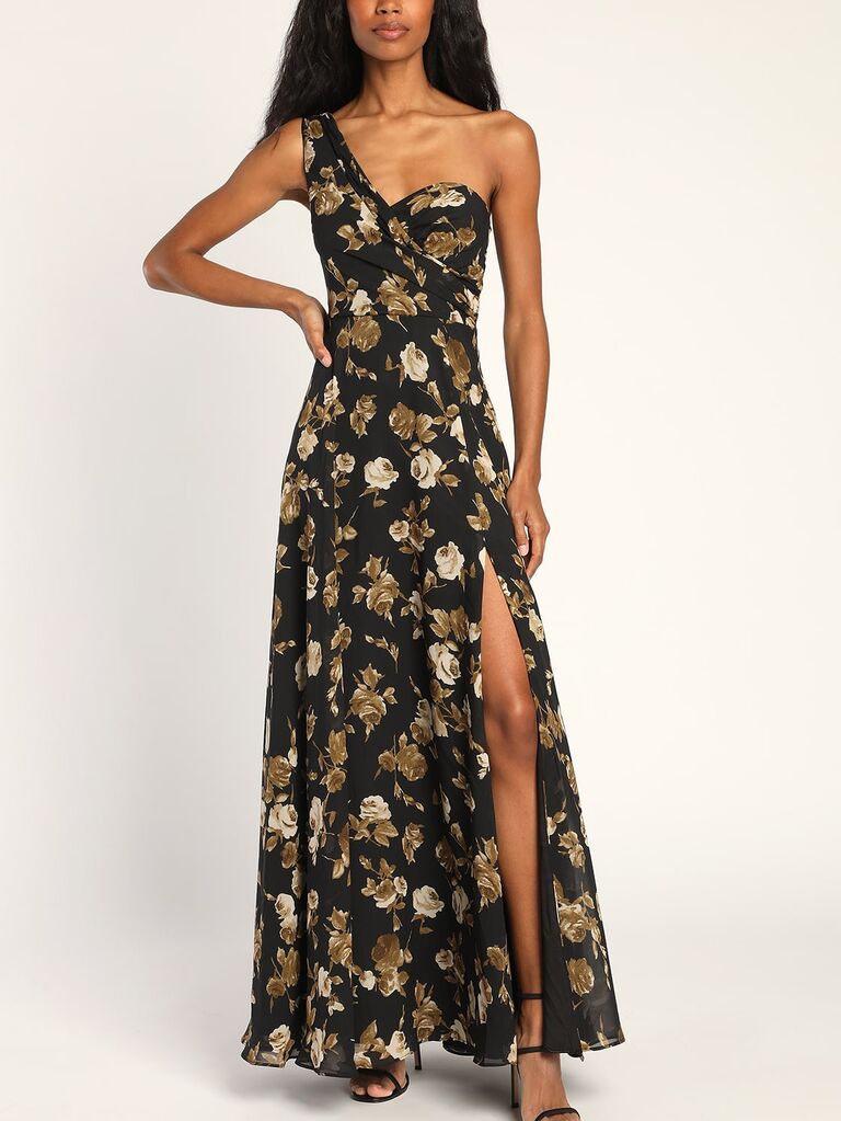 Model wearing a black and gold floral one-shoulder maxi dress with a sweetheart neckline