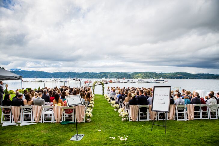 The ceremony took place on the front lawn of Alderbrook Resort and Spa in Union, Washington, with a beautiful backdrop of Hood Canal and Mount Ellinor in the distance. Arrangements perched on top of birch logs lined the aisle, leading up to the arch draped in hydrangeas, garden roses and greenery.