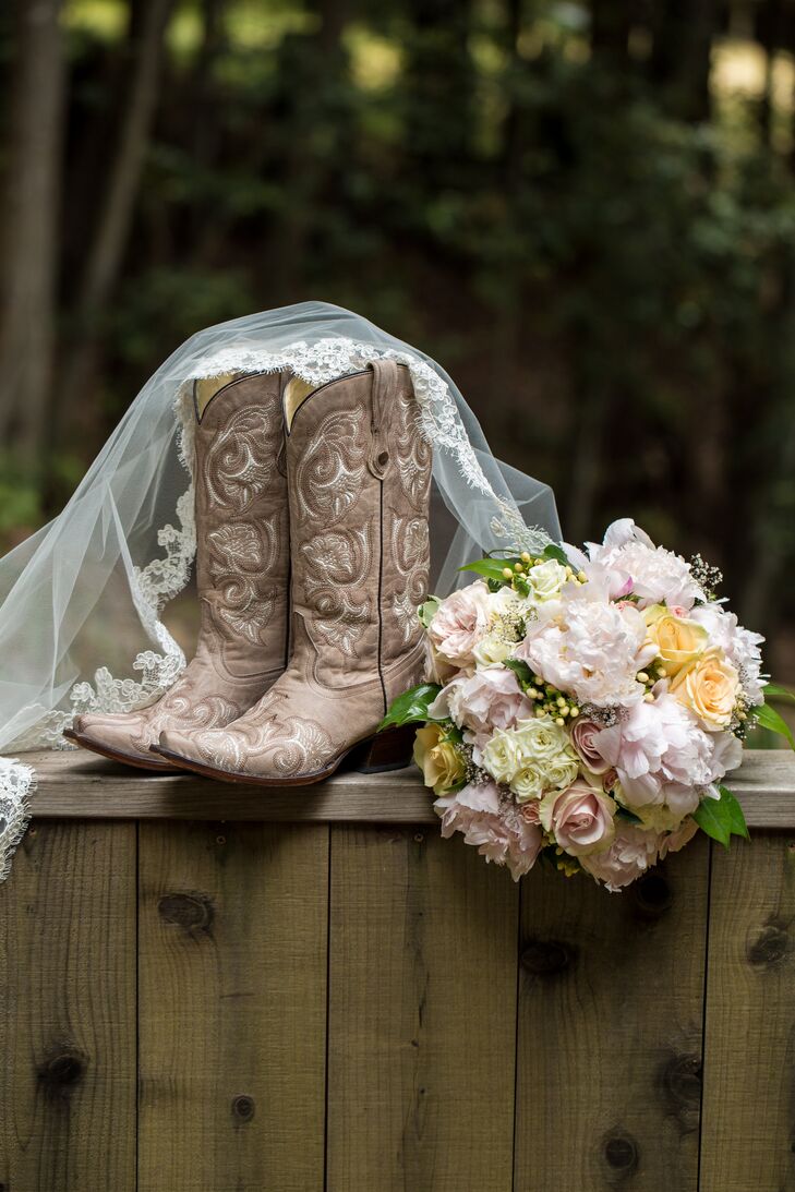 Allyson accessorized her traditional lace Monique Lhuillier gown with a lace-edged veil, brown cowboy boots and a bouquet filled with yellow, ivory and pink blooms.