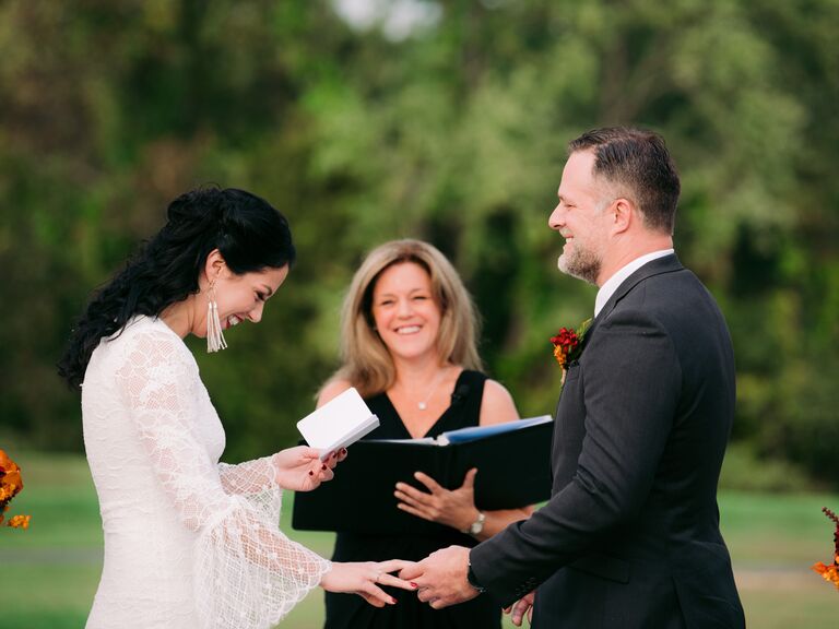 Couple exchanging vows laughing