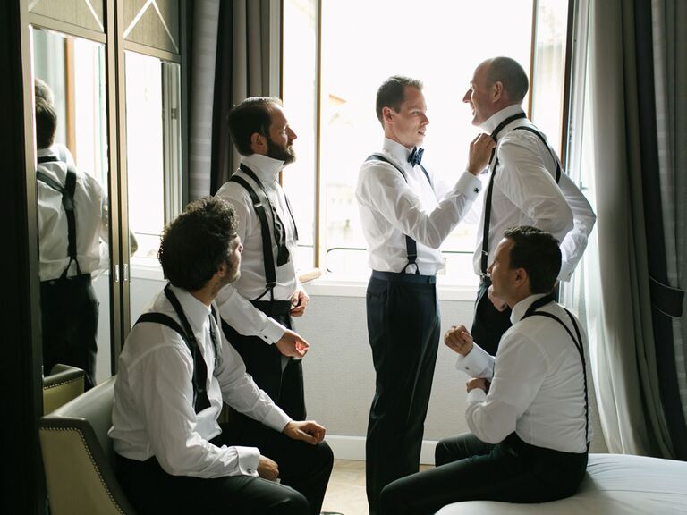 Groomsmen getting ready with groom on wedding morning