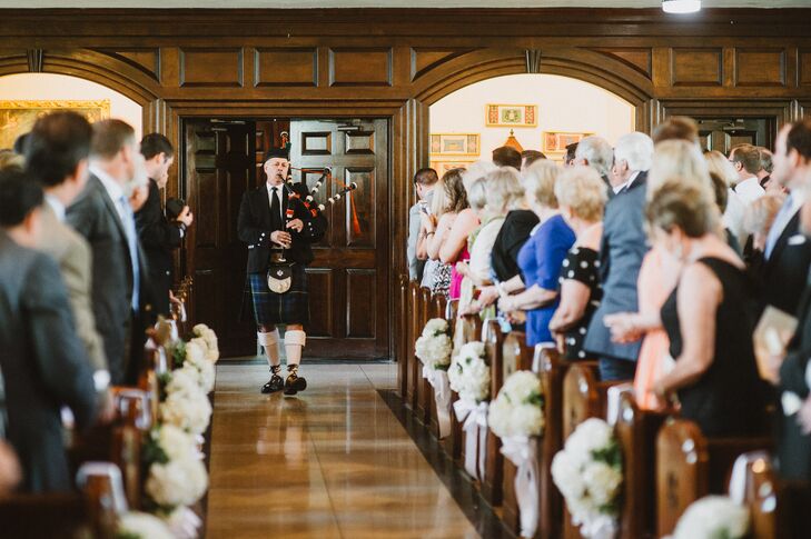 A bagpiper preceded Beth and her father down the aisle. The aisle was decorated with small bouquets of white hydrangeas.