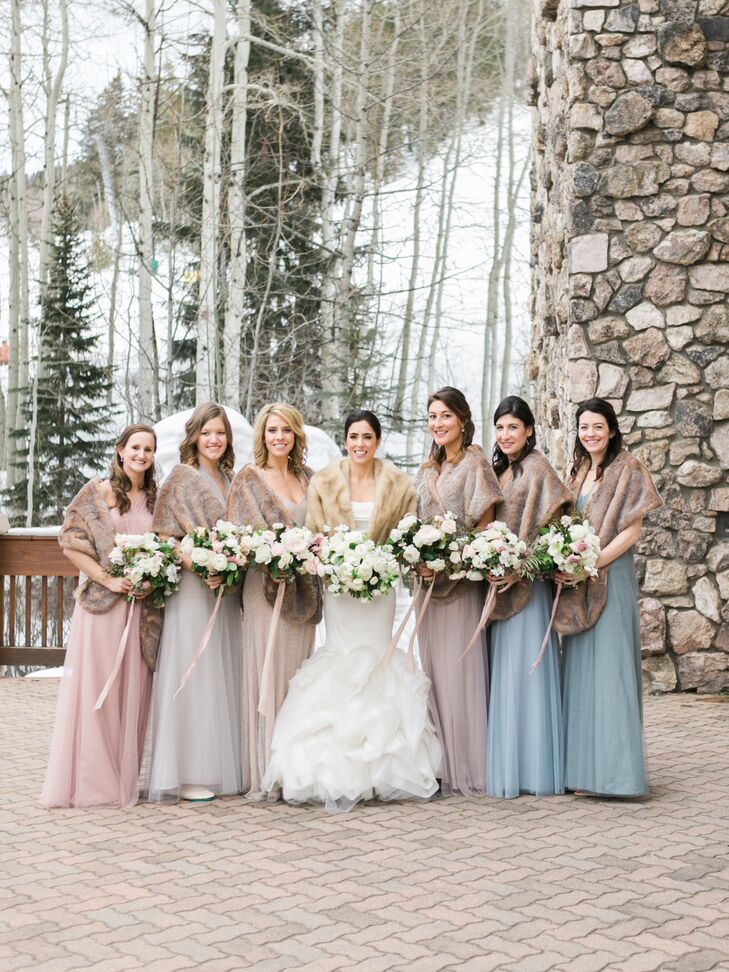 The bridesmaids wore dresses in different colors and styles, with a romantic tulle fabric serving as the common thread between them. Ashley gifted her bridesmaids faux-fur stoles from Restoration Hardware. “They were a hit,” she says.