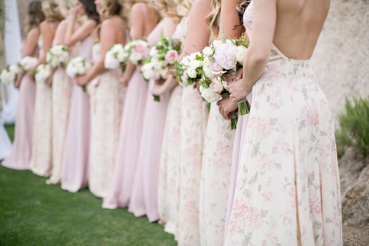 Bridesmaids wore soft and flowing gowns in alternating light pink and floral from Reformation. Their bouquets featured light pink and white florals.