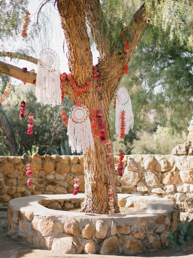 tree decorated with flower garlands and dream catchers