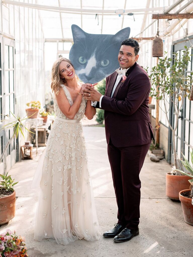 Couple holding giant cat cutout
