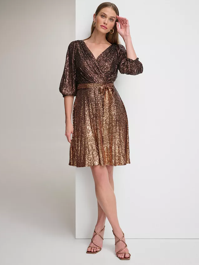 Model wearing a sequin dress in gold