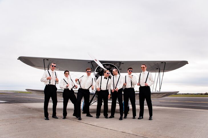 Groomsmen took the opportunity to pose on the airport runway in front of a small propeller plane in their matching suspenders.
