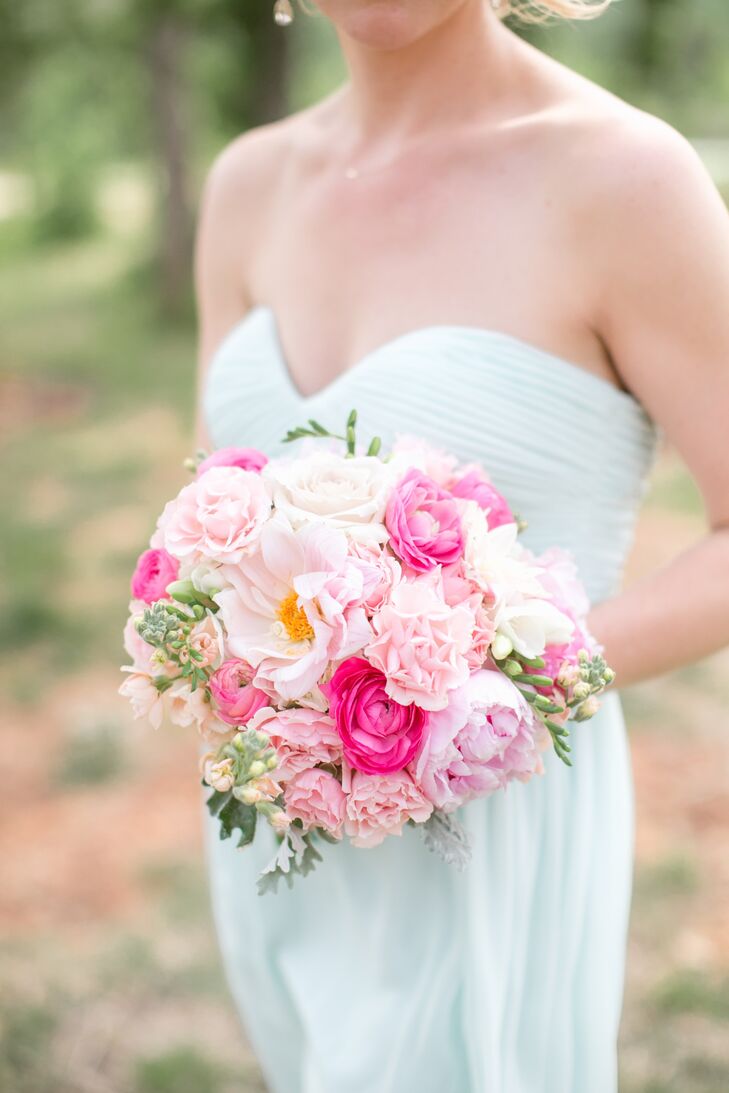 The bridesmaids carried a bright mix of pink blooms including peonies, stock, roses and vibrantly colored ranunculuses.