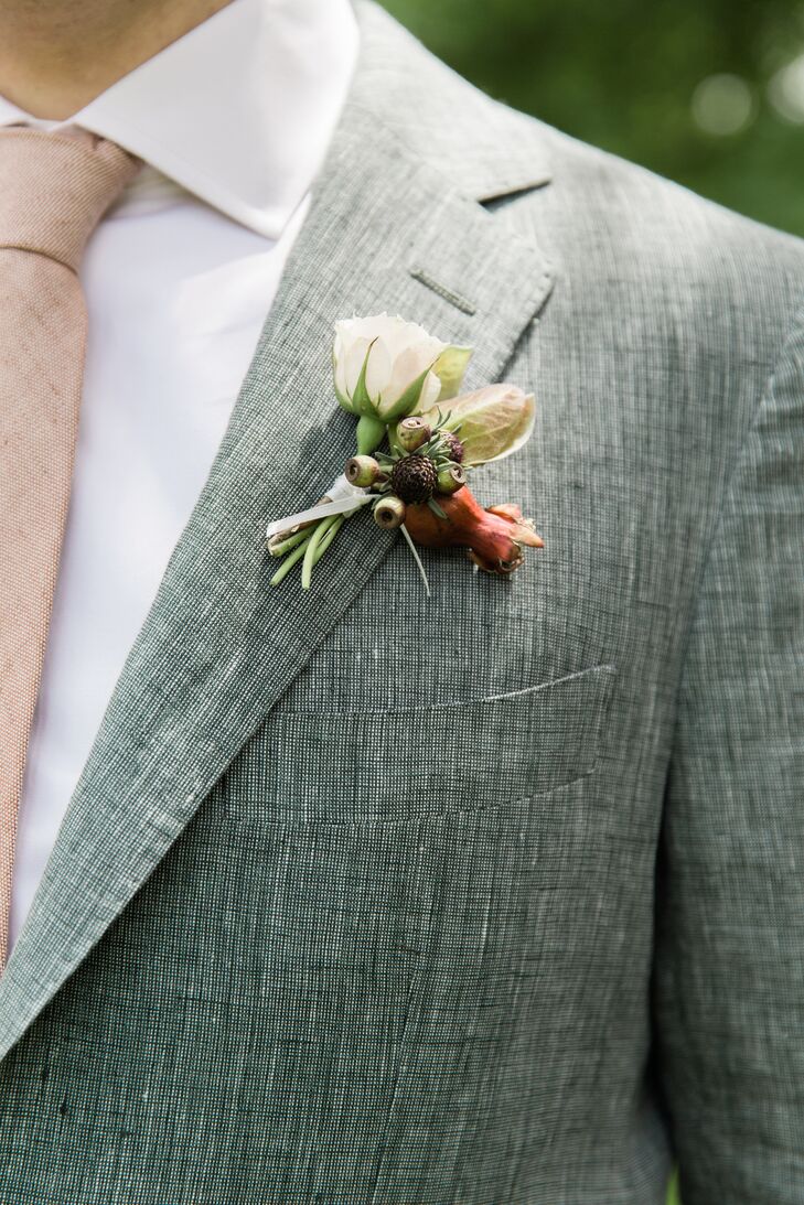 The groom's boutonniere echoed the foliage and florals of the Shavuot-inspired chuppah.