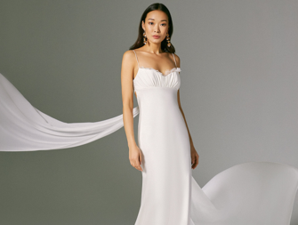 Satin gown with lace detailing on neckline and chiffon tie streamers on train