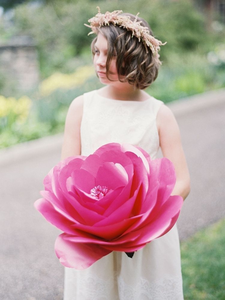 flower girl holding oversized paper flower wedding bouquet alternative