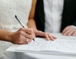 Bride signing marriage license