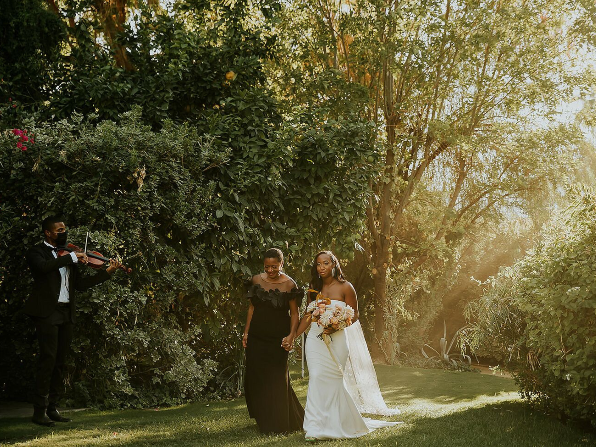 Bride being walked down the aisle by woman