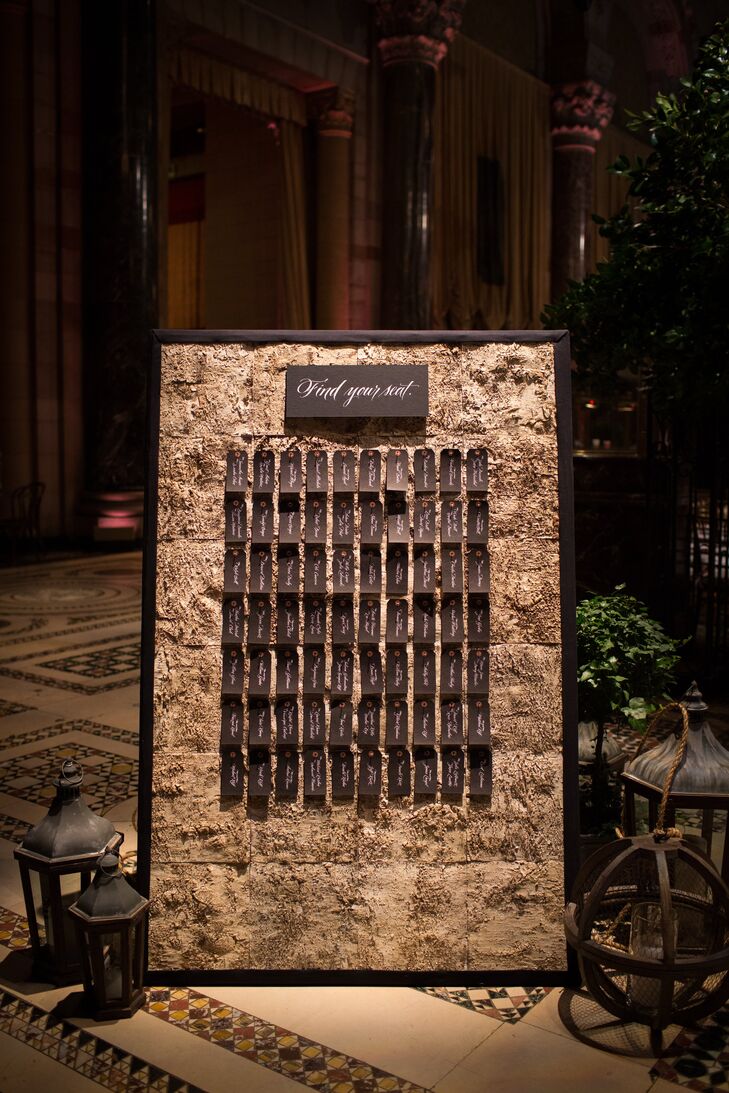 “I knew that I didn’t want classic folding cards,” Leigh recalls of the escort card display. Instead, they used a custom board covered in birch wood that created a “rustic winery feel.” Individual black tags finished the look.
