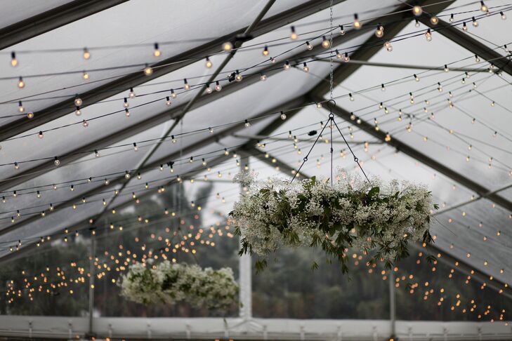 Complementing the couple’s natural theme, baby’s breath chandeliers were hung from their tented ceiling for both the ceremony and reception.
