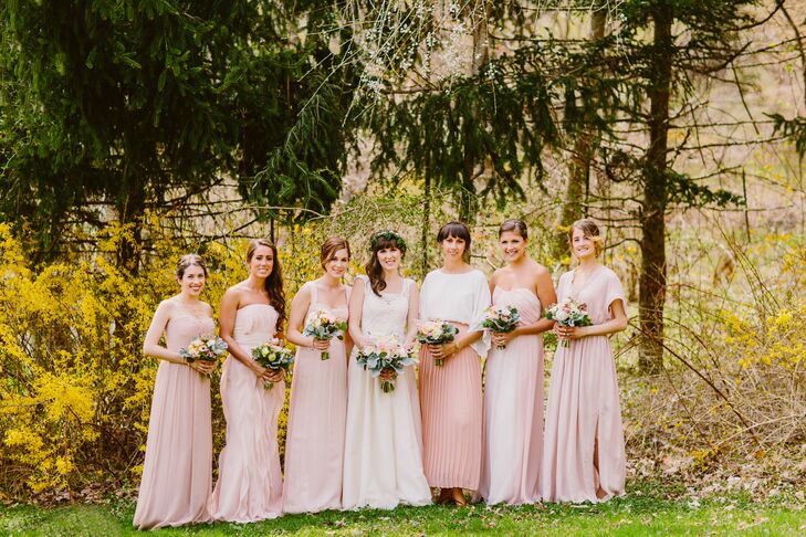 The bride stood with her bridal party, who wore a variety of blush dresses that were individually picked out by each bridesmaid.