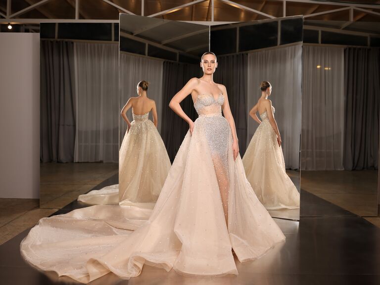 model wearing glitter tulle ball gown with cathedral train