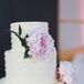 Swiss dots on this white buttercream cake felt timeless, just like Melissa and Matt’s wedding. A pair of blush peonies and an elegant silver cake stand dressed up the style.
