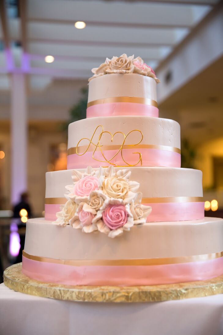 A pink ribbon was wrapped around each layer of the romantic rose decorated cake.
