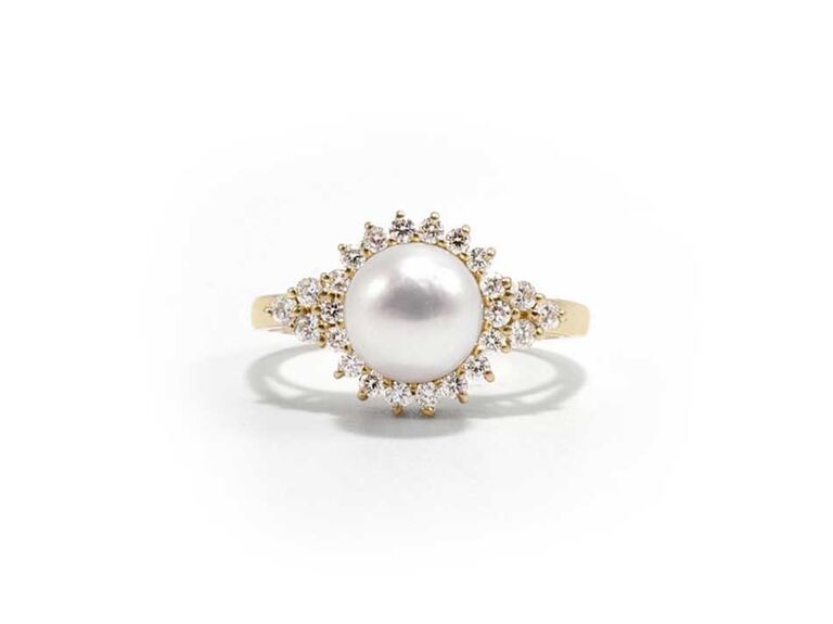 Pearl engagement ring with diamond cluster halo setting