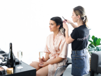 Bride getting hair styled on wedding day