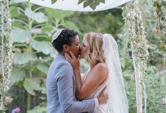 Couple kiss at wedding ceremony